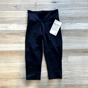 BNWT! Mid-rise compression 3/4 tights. Black w/reflective dots. Size XS.